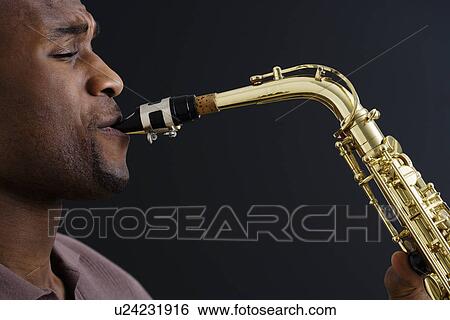 Stock Photograph - Close up of man playing saxophone. Fotosearch