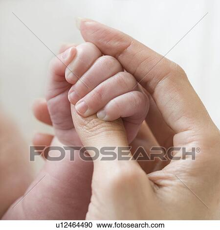 Close up of mother holding baby’s hand View Large Photo Image Stock Image - Close up of mother holding baby’s hand. Fotosearch