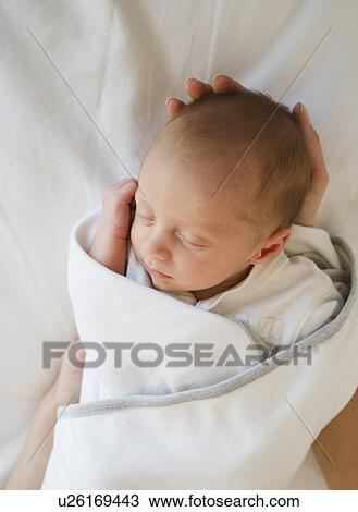 Stock Image - Close up of newborn baby sleeping. Fotosearch