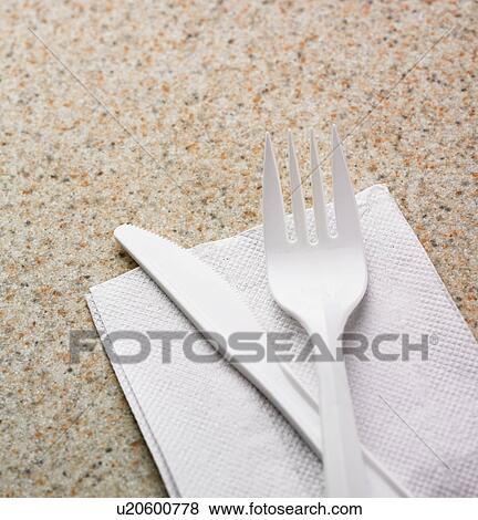 Close up of plastic knife and fork on napkin View Large Photo Image Stock Photo - Close up of plastic knife and fork on napkin. Fotosearch
