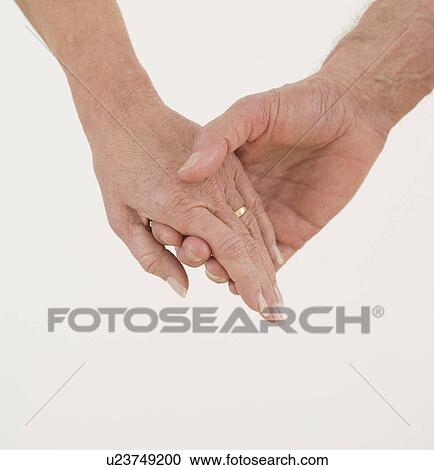 Close up of senior couple holding hands View Large Photo Image Stock Image - Close up of senior couple holding hands. Fotosearch