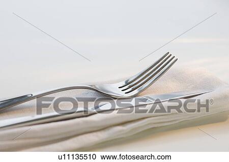 Stock Image - Close up of silverware on napkin. Fotosearch