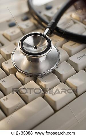 Close up of stethoscope on computer keyboard View Large Photo Image Stock Photo - Close up of stethoscope on computer keyboard. Fotosearch