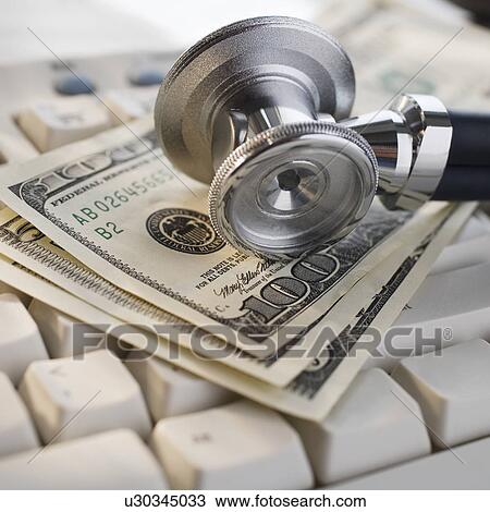 Close up of stethoscope on US Dollars and computer keyboard View Large Photo Image Stock Image - Close up of stethoscope on US Dollars and computer keyboard. Fotosearch
