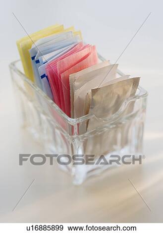 Stock Photo - Close up of sugar and sweetener packets. Fotosearch