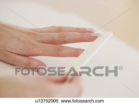 Close up of woman filing fingernails View Large Photo Image Stock Photography - Close up of woman filing fingernails. Fotosearch
