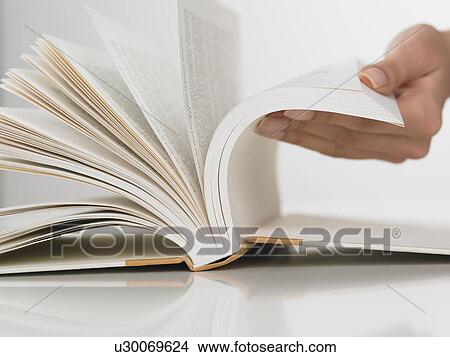Close up of woman flipping pages in book View Large Photo Image Picture - Close up of woman flipping pages in book. Fotosearch