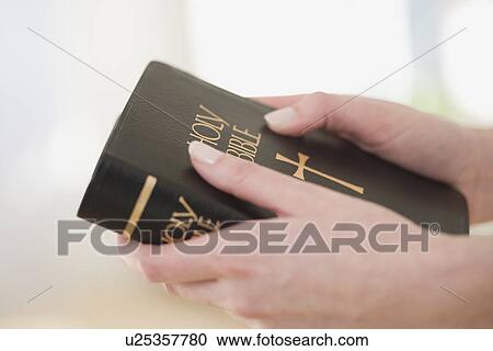 Close up of woman holding Bible View Large Photo Image Stock Image - Close up of woman holding Bible. Fotosearch
