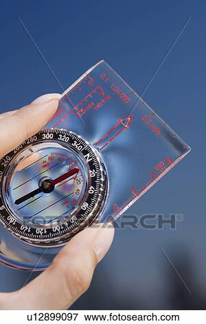 Close up of woman holding compass View Large Photo Image Stock Photo - Close up of woman holding compass. Fotosearch