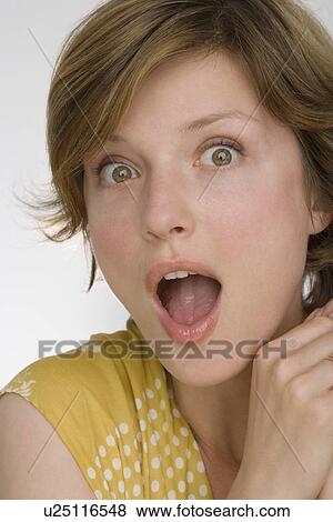 Stock Photo - Close up of woman looking surprised. Fotosearch