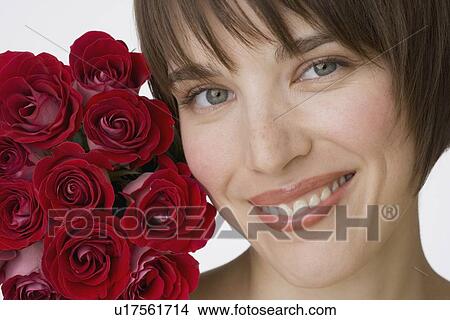 Picture - Close up of woman next to flowers. Fotosearch