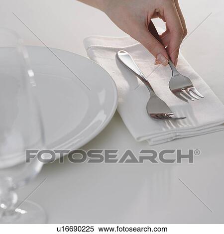 Close up of woman putting fork in table setting View Large Photo Image Stock Photography - Close up of woman putting fork in table setting . Fotosearch
