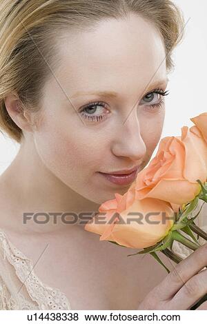 Close up of woman smelling flowers View Large Photo Image Stock Photo - Close up of woman smelling flowers. Fotosearch