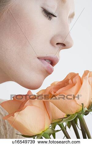 Close up of woman smelling flowers View Large Photo Image Stock Photo - Close up of woman smelling flowers. Fotosearch