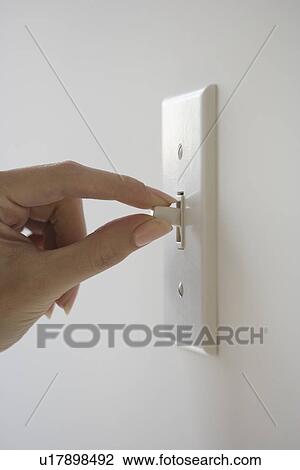 Close up of woman turning light switch View Large Photo Image Stock Image - Close up of woman turning light switch. Fotosearch