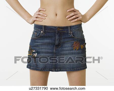 Close up of woman with bare midriff wearing mini skirt View Large Photo Image Stock Image - Close up of woman with bare midriff wearing mini skirt. Fotosearch