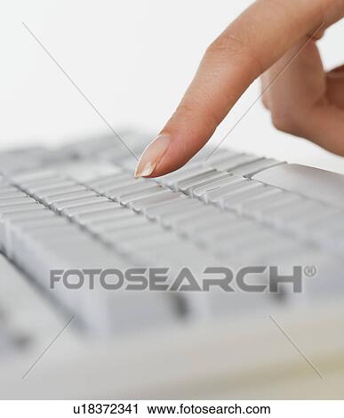 Close up of woman's finger over computer keyboard View Large Photo Image Stock Image - Close up of woman's finger over computer keyboard. Fotosearch