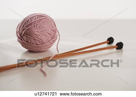 Close up studio shot of ball of yarn and knitting needles View Large Photo Image Stock Image - Close up studio shot of ball of yarn and knitting needles. Fotosearch