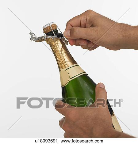 Close up studio shot of man opening champagne View Large Photo Image Stock Image - Close up studio shot of man opening champagne. Fotosearch