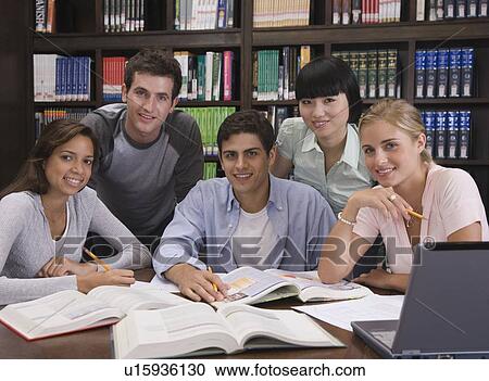 Stock Image - College students studying in library. Fotosearch