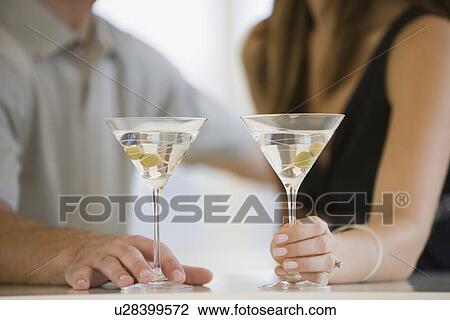 Couple drinking martinis View Large Photo Image Stock Image - Couple drinking martinis. Fotosearch