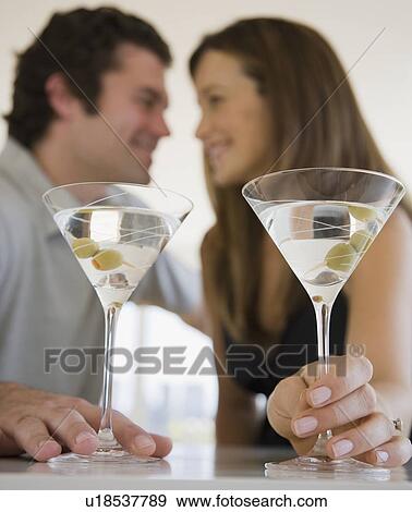 Couple drinking martinis View Large Photo Image Stock Photo - Couple drinking martinis. Fotosearch
