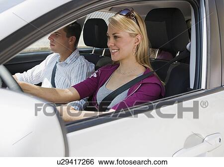 Stock Photograph - Couple driving in car. Fotosearch