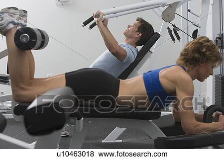 Couple exercising at gym View Large Photo Image Stock Photo - Couple exercising at gym. Fotosearch