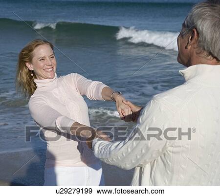 Couple holding hands at beach View Large Photo Image Stock Photo - Couple holding hands at beach. Fotosearch