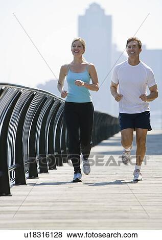 Stock Photo - Couple jogging in urban area. Fotosearch