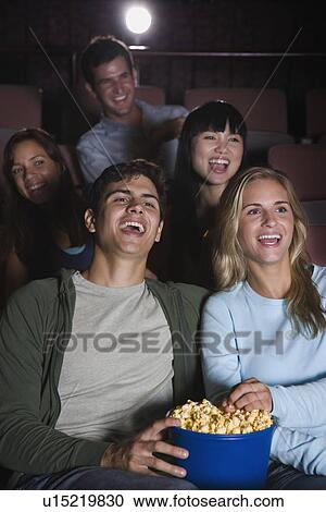 Couple laughing in movie theater View Large Photo Image Stock Image - Couple laughing in movie theater. Fotosearch
