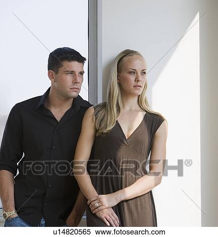 Couple leaning on wall View Large Photo Image Stock Photography - Couple leaning on wall. Fotosearch