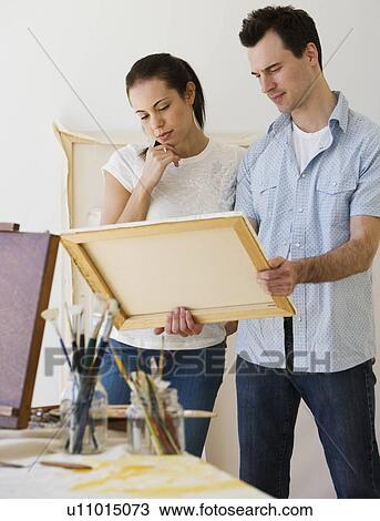 Couple looking at artwork View Large Photo Image Stock Image - Couple looking at artwork. Fotosearch