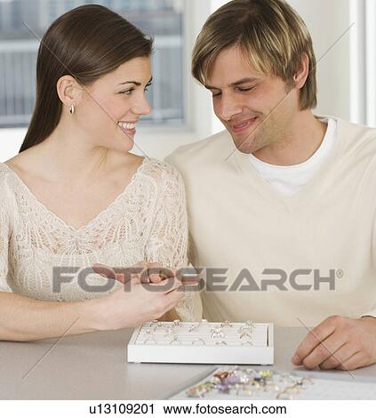 Stock Image - Couple looking at engagement rings. Fotosearch