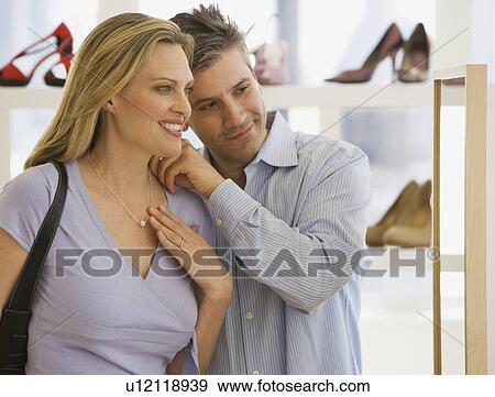 Couple looking at necklace in boutique View Large Photo Image Stock Photo - Couple looking at necklace in boutique. Fotosearch