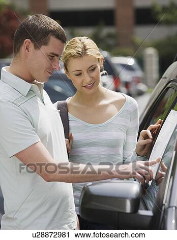 Couple looking at new car View Large Photo Image Stock Image - Couple looking at new car. Fotosearch