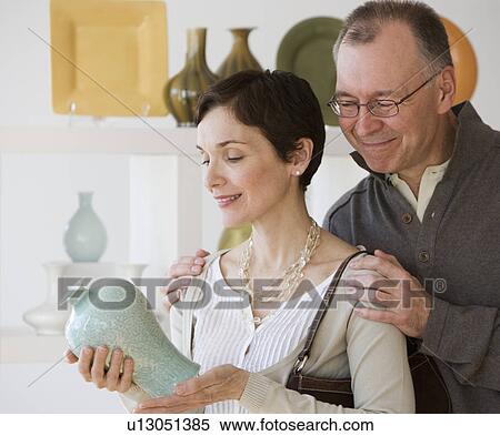 Stock Photography - Couple looking at pottery in store. Fotosearch