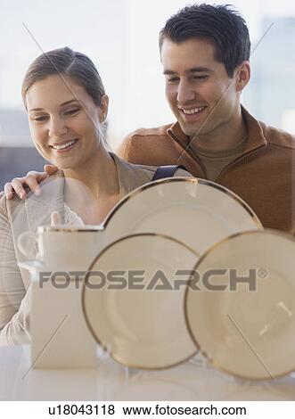 Couple looking at tableware in shop window View Large Photo Image Stock Photo - Couple looking at tableware in shop window. Fotosearch