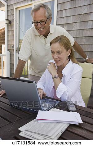 Picture - Couple paying bills online. Fotosearch