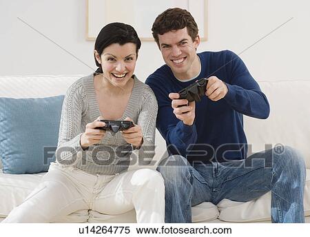 Couple playing video games View Large Photo Image Stock Photography - Couple playing video games. Fotosearch