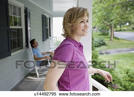 Stock Photography - Couple relaxing on porch. Fotosearch