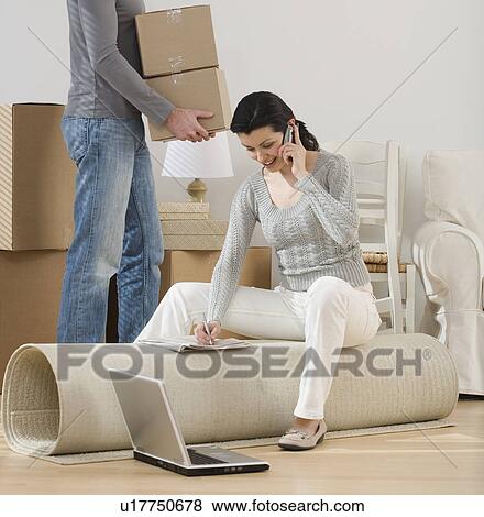 Couple setting up new house View Large Photo Image Stock Photo - Couple setting up new house. Fotosearch
