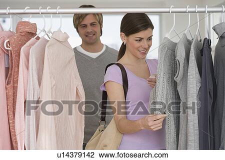 Couple shopping for clothing View Large Photo Image Stock Image - Couple shopping for clothing. Fotosearch