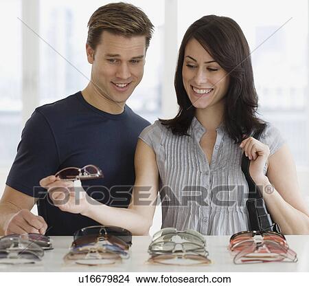 Couple shopping for sunglasses View Large Photo Image Picture - Couple shopping for sunglasses. Fotosearch
