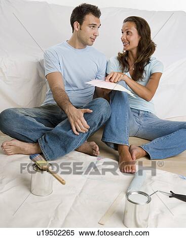 Couple sitting on tarp looking at paint swatches View Large Photo Image Stock Photography - Couple sitting on tarp looking at paint swatches. Fotosearch