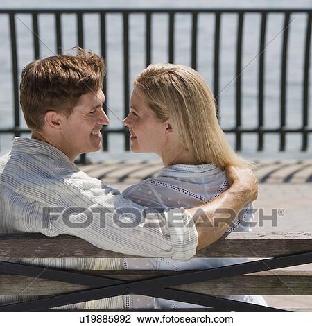 Stock Image - Couple smiling at each other. Fotosearch