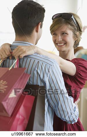 Stock Photo - Couple smiling at each other. Fotosearch