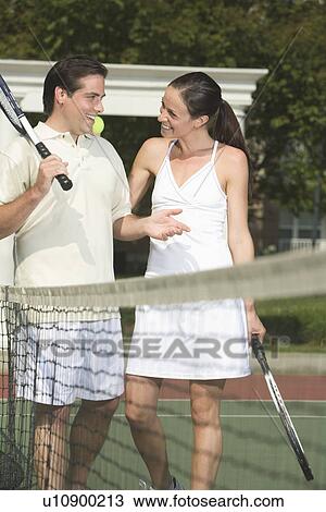 Couple talking on tennis court View Large Photo Image Stock Image - Couple talking on tennis court. Fotosearch