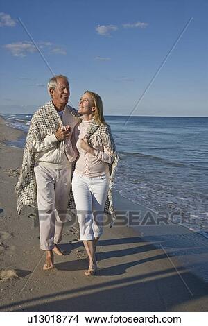 Couple walking on beach View Large Photo Image Picture - Couple walking on beach. Fotosearch