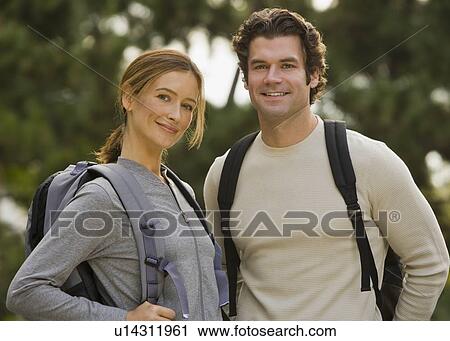 Couple wearing backpacks in woods View Large Photo Image Stock Image - Couple wearing backpacks in woods. Fotosearch